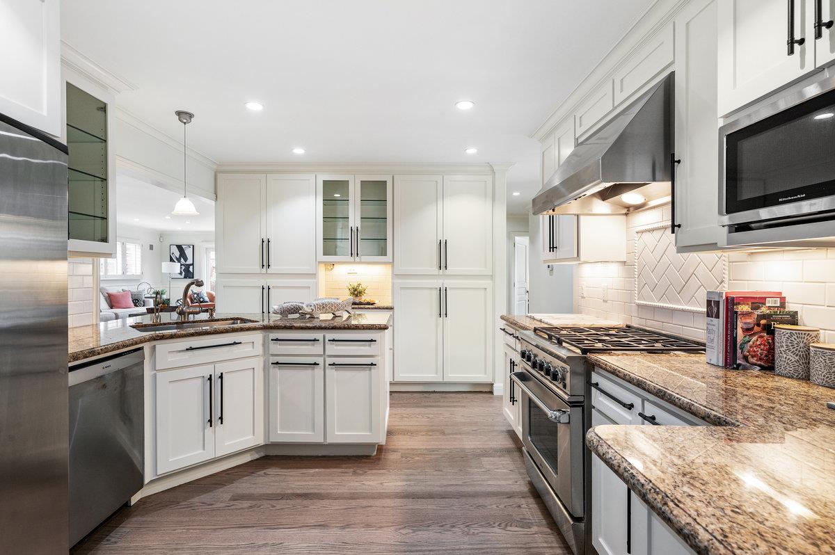 3524 Michael Drive San Mateo, CA 94403 - Photo 5 of 39 a kitchen with stainless steel appliances granite countertop a stove top oven a sink dishwasher and a microwave oven with large wooden cabinets