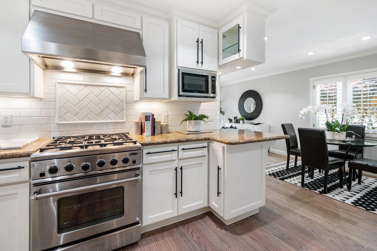 3524 Michael Drive San Mateo, CA 94403 - Photo 8 of 39 a kitchen with stainless steel appliances a stove a sink cabinets and wooden floor