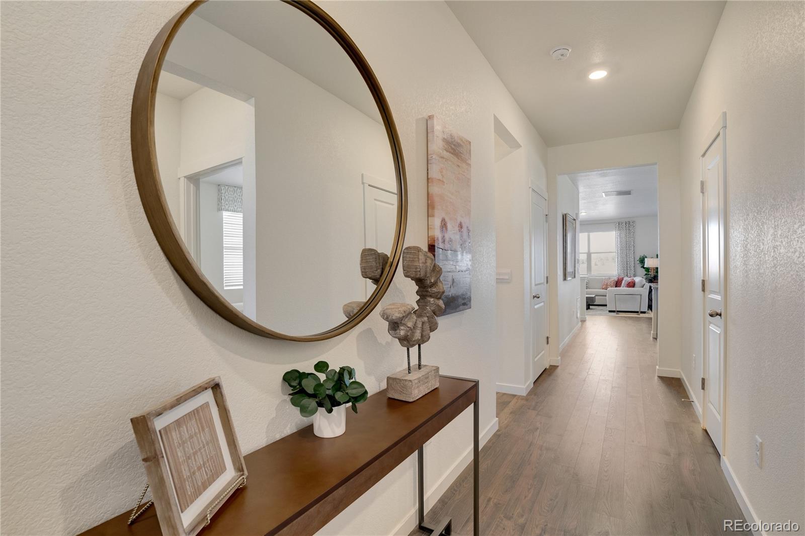 622 Sawyers Pond Drive Severance, CO 80550 - Photo 2 of 25 a view of a hallway with wooden floor and glass windows
