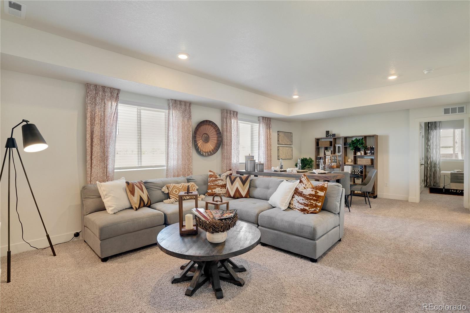 622 Sawyers Pond Drive Severance, CO 80550 - Photo 23 of 25 a living room with furniture and a large window