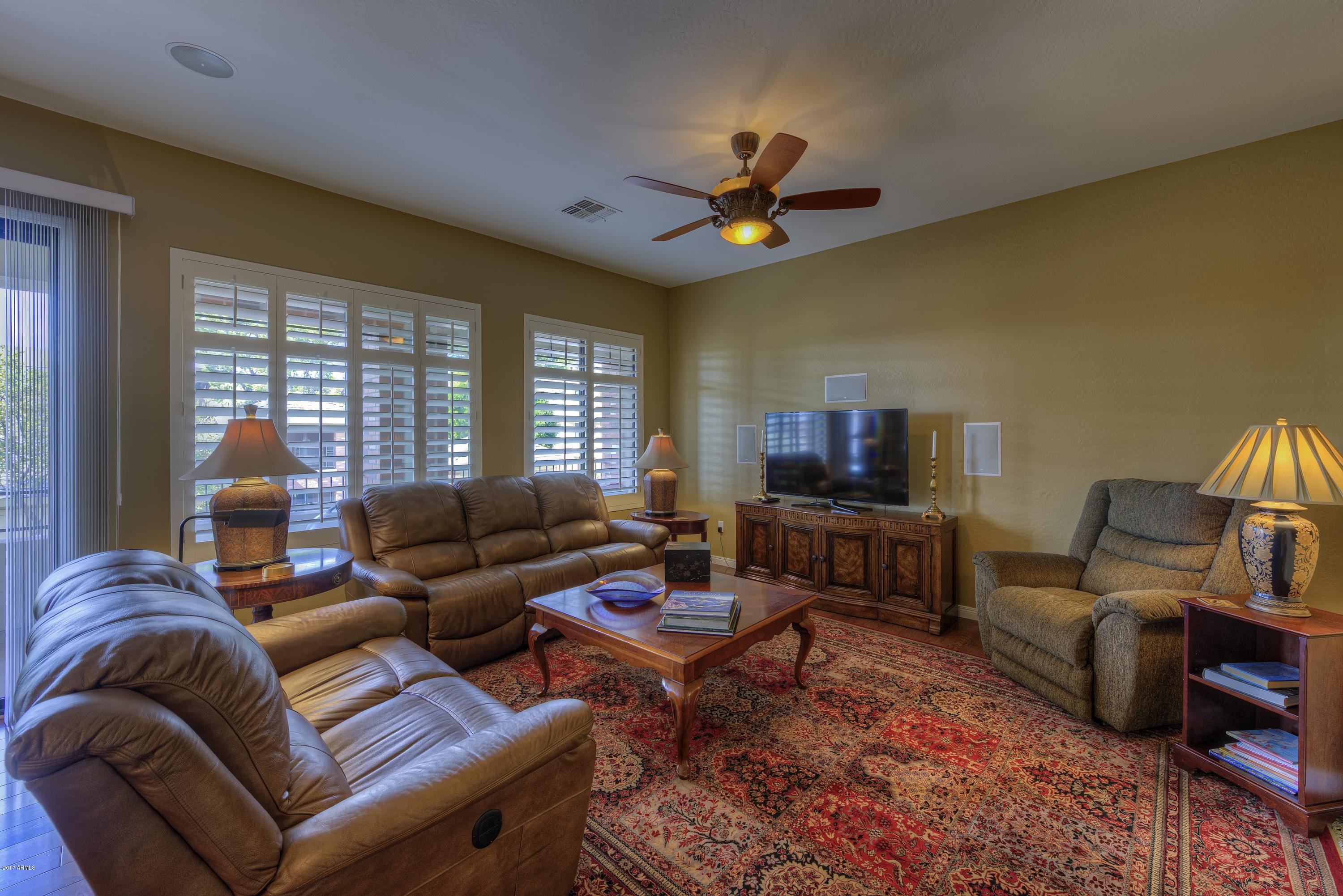 4488 East Thomas Road, Unit 2046 Phoenix, AZ 85018 - Photo 1 of 18 a living room with furniture and a flat screen tv