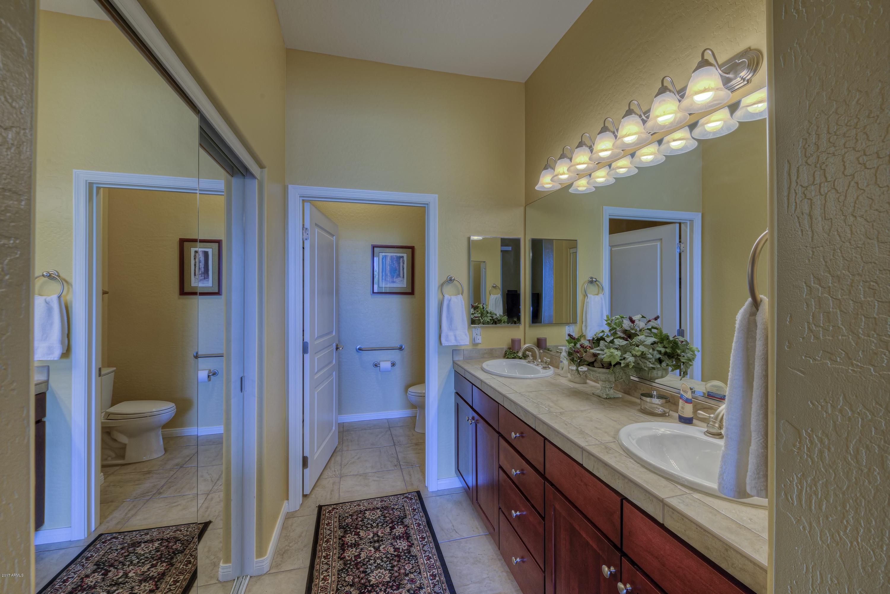 4488 East Thomas Road, Unit 2046 Phoenix, AZ 85018 - Photo 12 of 18 a bathroom with a sink and a mirror