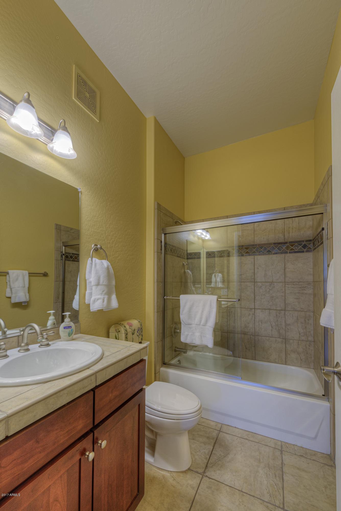 4488 East Thomas Road, Unit 2046 Phoenix, AZ 85018 - Photo 14 of 18 a bathroom with a sink a toilet and shower