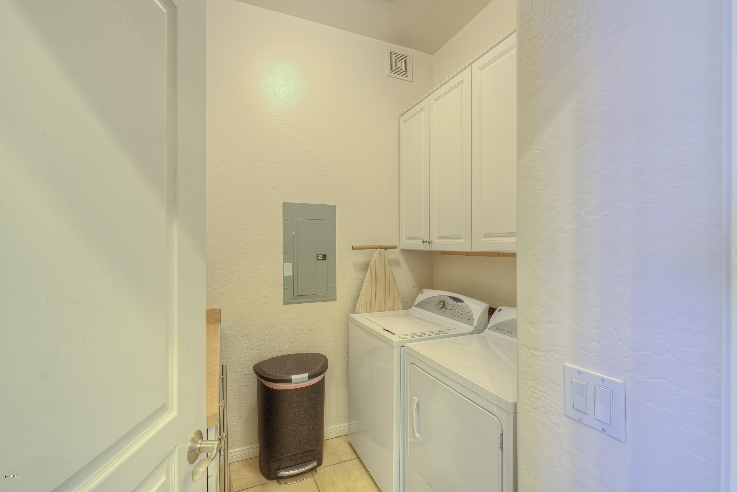 4488 East Thomas Road, Unit 2046 Phoenix, AZ 85018 - Photo 15 of 18 a bathroom with a granite countertop sink a toilet and a shower