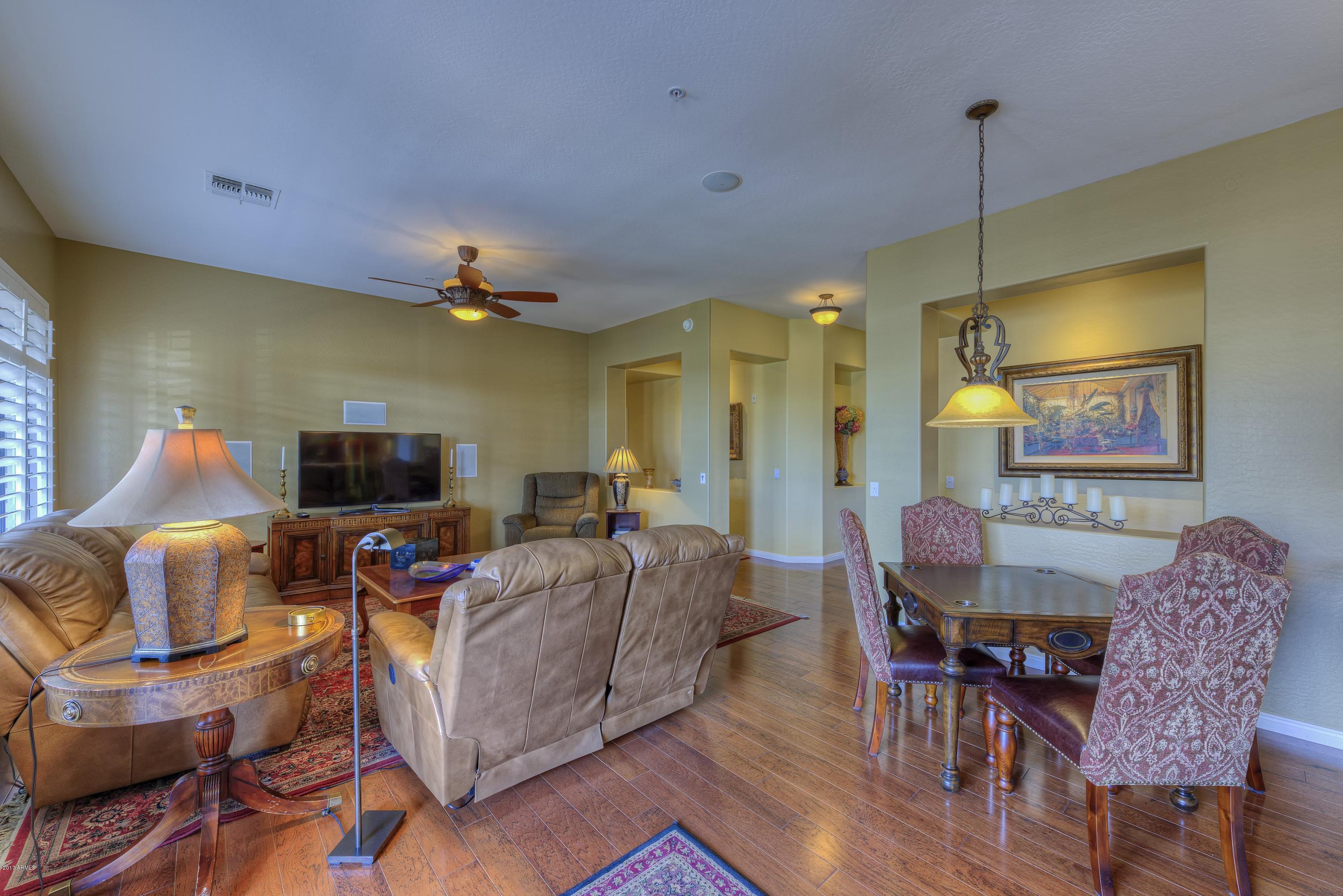 4488 East Thomas Road, Unit 2046 Phoenix, AZ 85018 - Photo 2 of 18 a living room with furniture and a flat screen tv