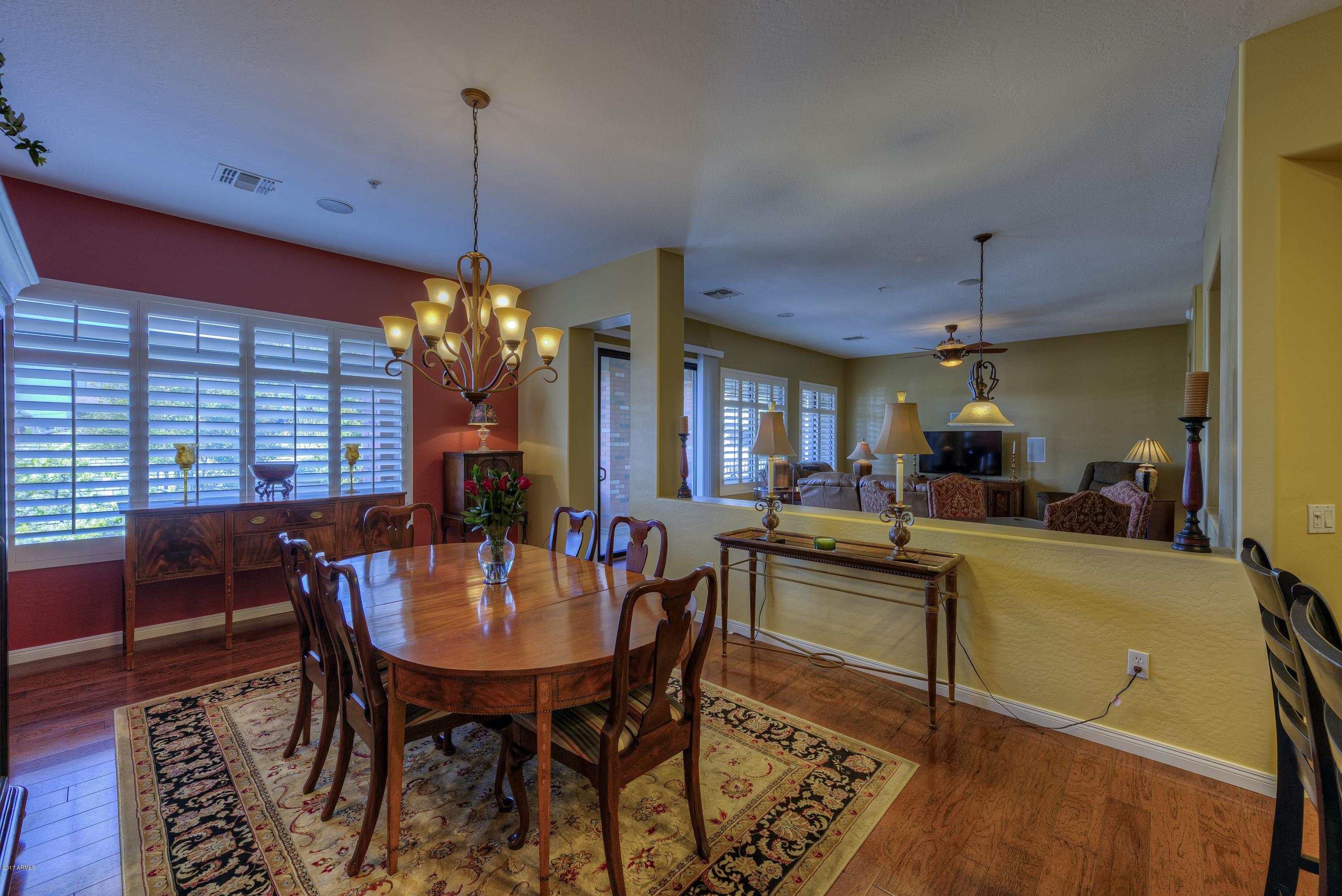 4488 East Thomas Road, Unit 2046 Phoenix, AZ 85018 - Photo 3 of 18 a view of a dining room with furniture window and wooden floor