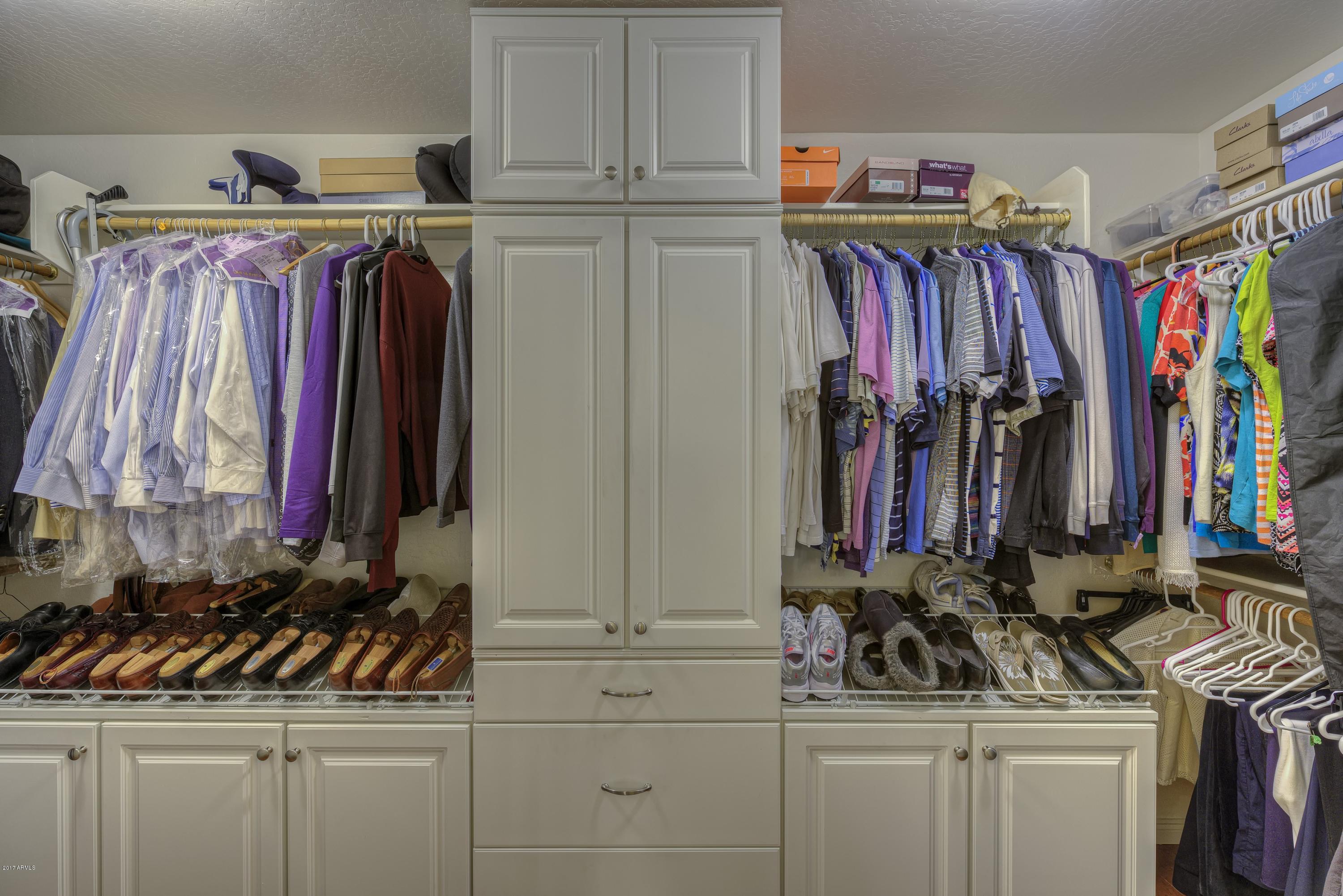 4488 East Thomas Road, Unit 2046 Phoenix, AZ 85018 - Photo 9 of 18 a view of walk in closet with clothes and shoes