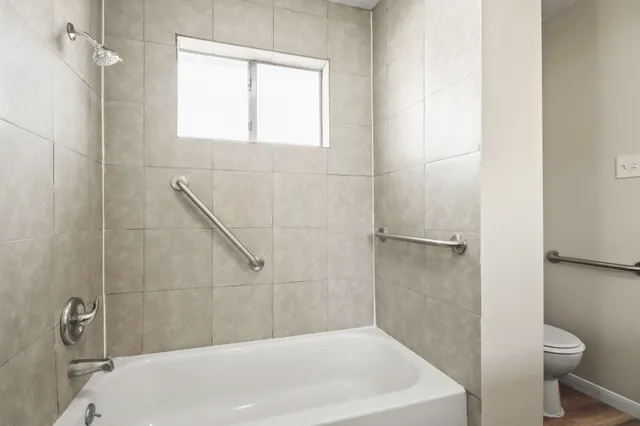 a bathroom with a white bath tub and a shower