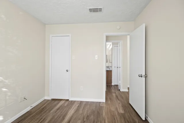 a view of a hallway with wooden floor