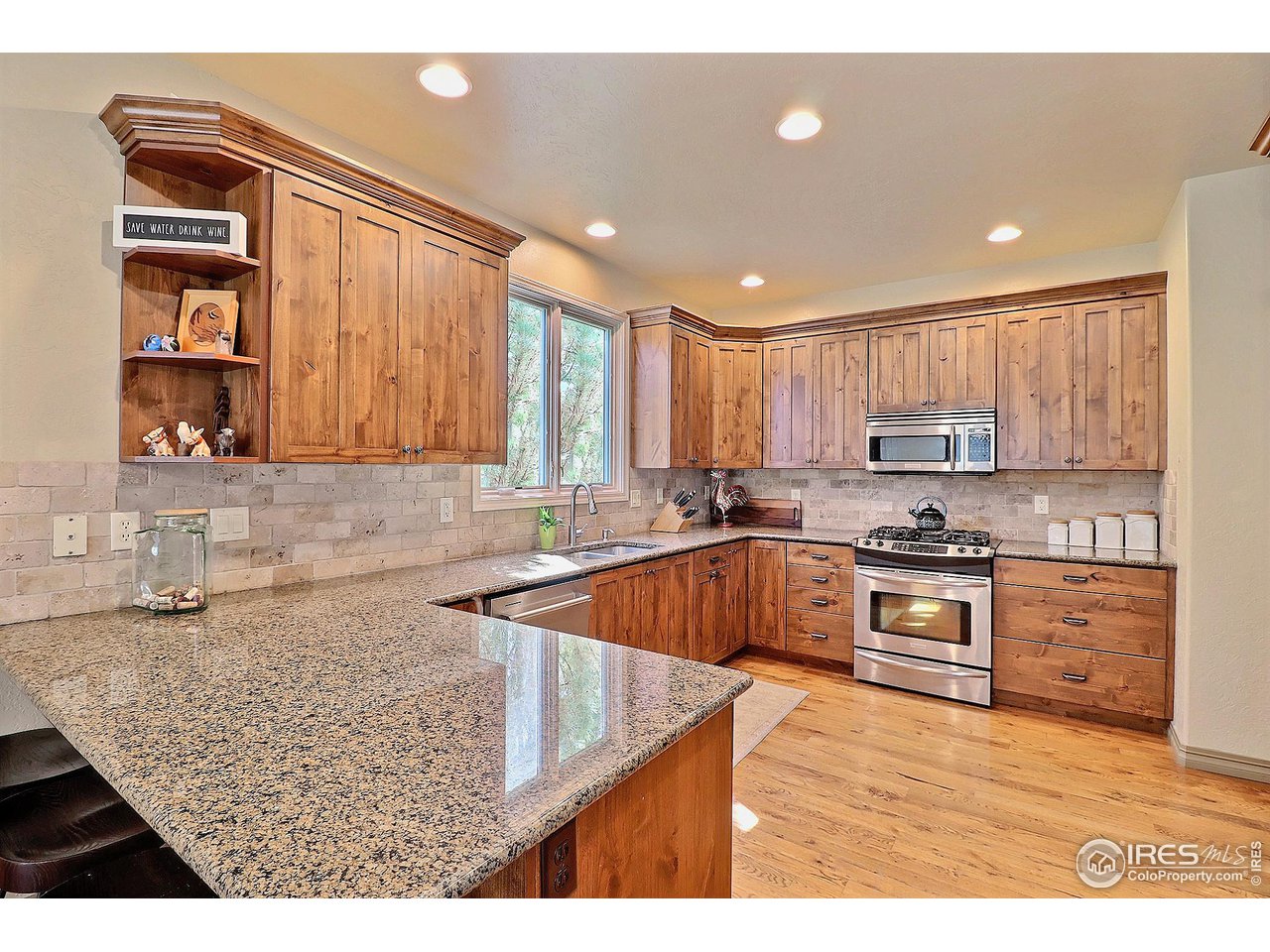 6801 West 34th St Road Greeley, CO 80634 - Photo 13 of 40 a kitchen with stainless steel appliances granite countertop a sink stove and cabinets