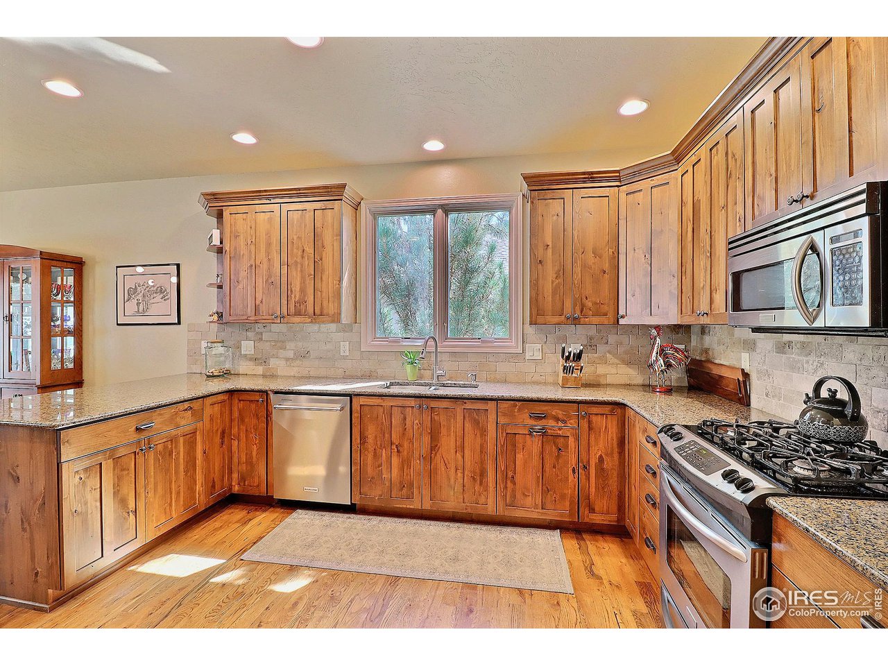 6801 West 34th St Road Greeley, CO 80634 - Photo 14 of 40 a kitchen with stainless steel appliances granite countertop a stove a sink and a microwave