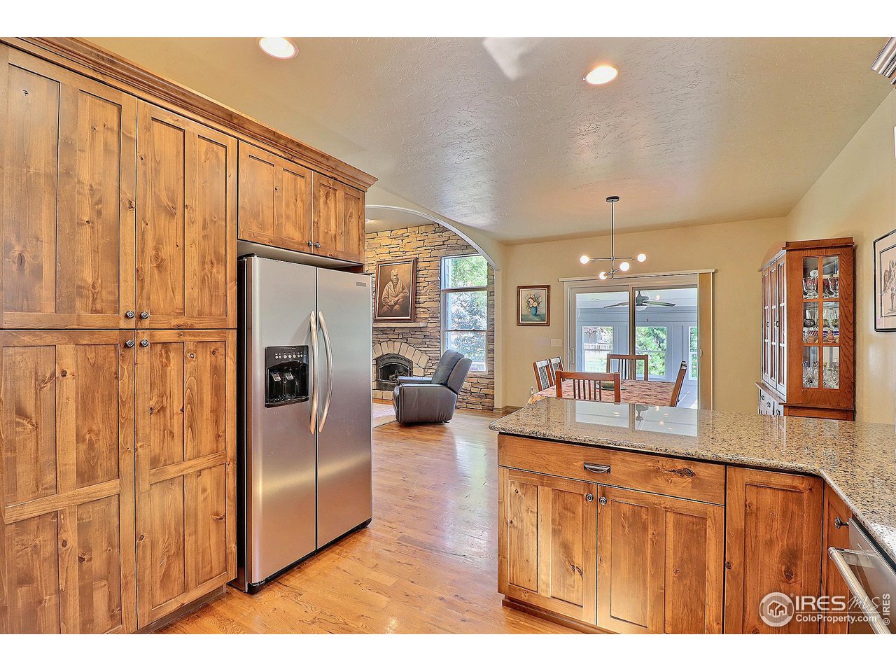 6801 West 34th St Road Greeley, CO 80634 - Photo 15 of 40 a kitchen with stainless steel appliances granite countertop a refrigerator a sink dishwasher with couches and flat screen tv
