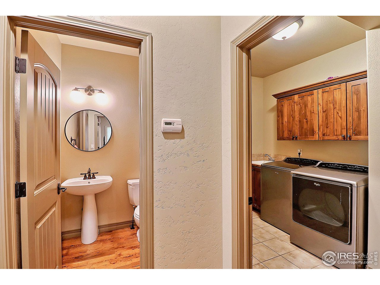 6801 West 34th St Road Greeley, CO 80634 - Photo 16 of 40 a bathroom with a toilet a sink and a mirror