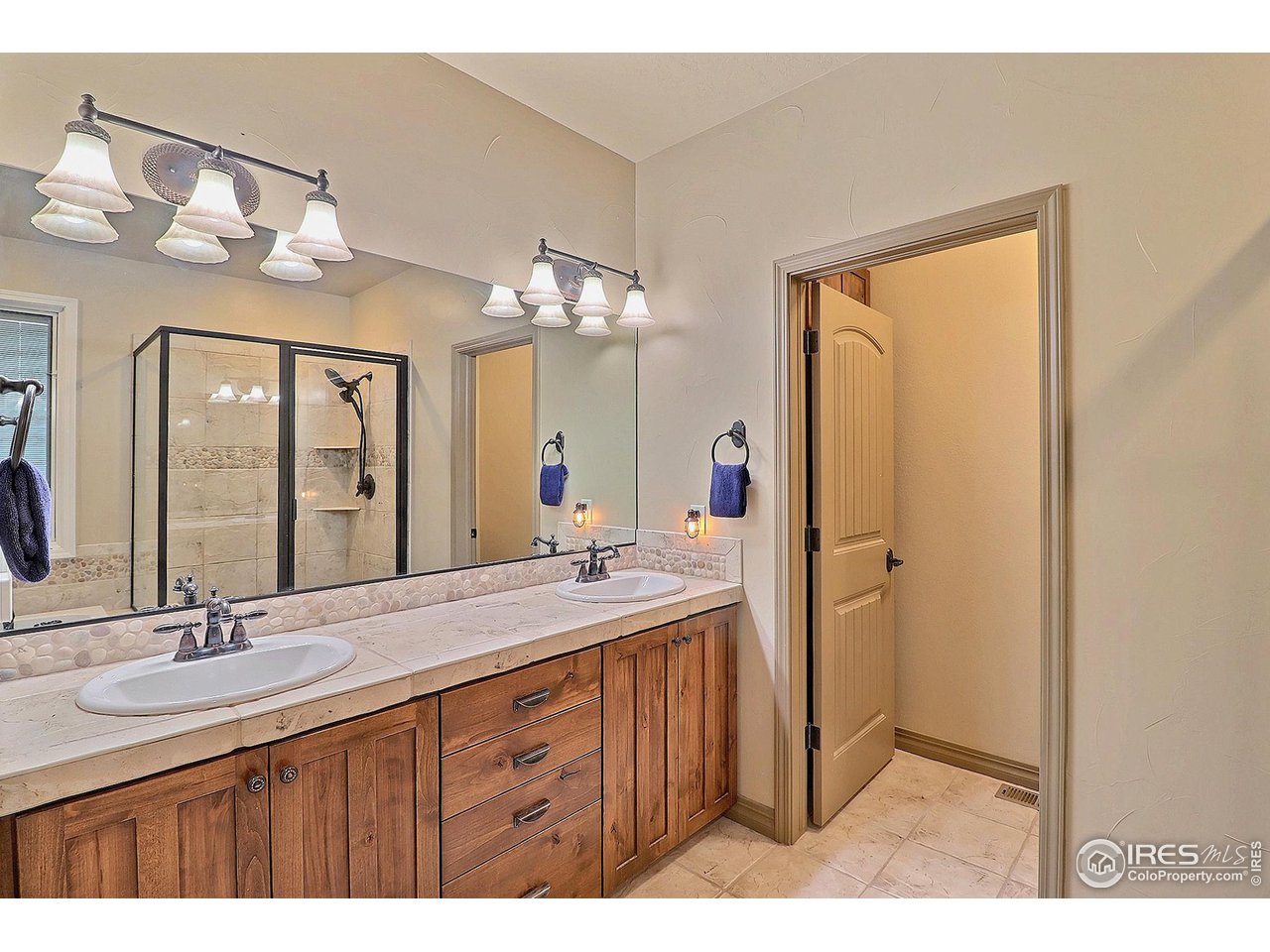 6801 West 34th St Road Greeley, CO 80634 - Photo 19 of 40 a bathroom with a double vanity sink and a mirror