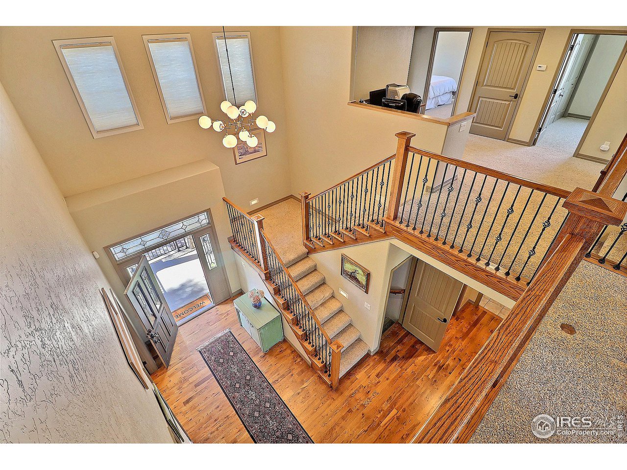 6801 West 34th St Road Greeley, CO 80634 - Photo 22 of 40 a view of stairs and hall with wooden floor