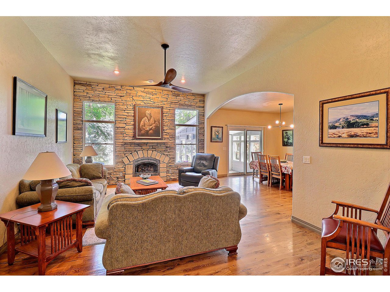 6801 West 34th St Road Greeley, CO 80634 - Photo 40 of 40 a living room with furniture a fireplace and a table