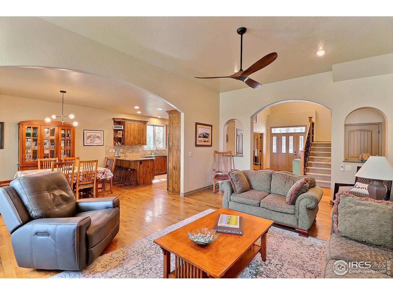 6801 West 34th St Road Greeley, CO 80634 - Photo 7 of 40 a living room with furniture a ceiling fan and a rug