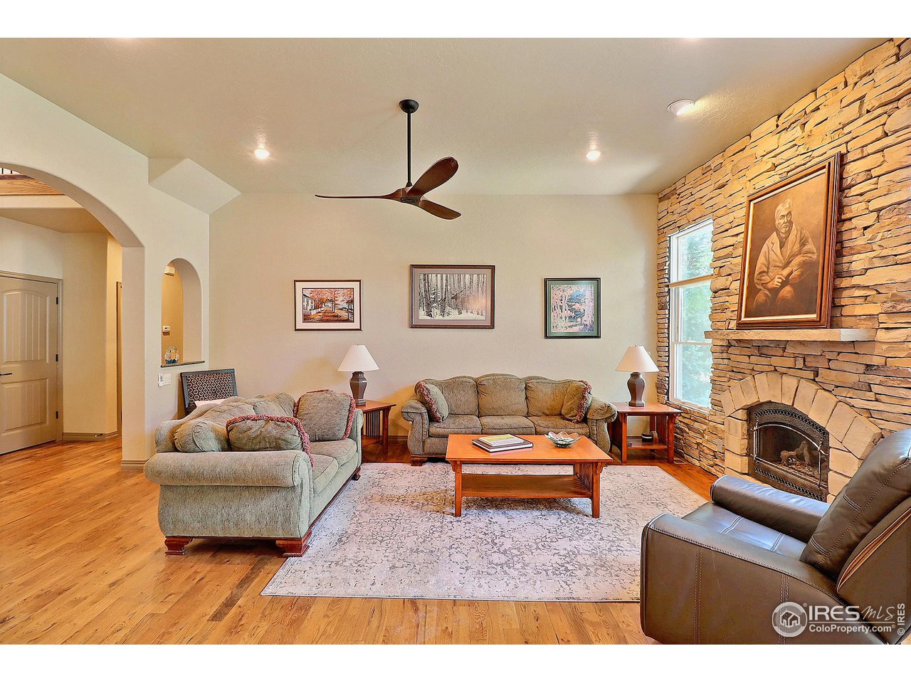 6801 West 34th St Road Greeley, CO 80634 - Photo 8 of 40 a living room with furniture and a fireplace