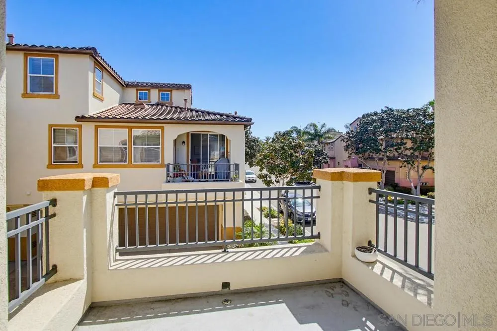 3643 Jetty Point Carlsbad, CA 92010 - Photo 13 of 37 a view of a white house with wooden floor and a small yard