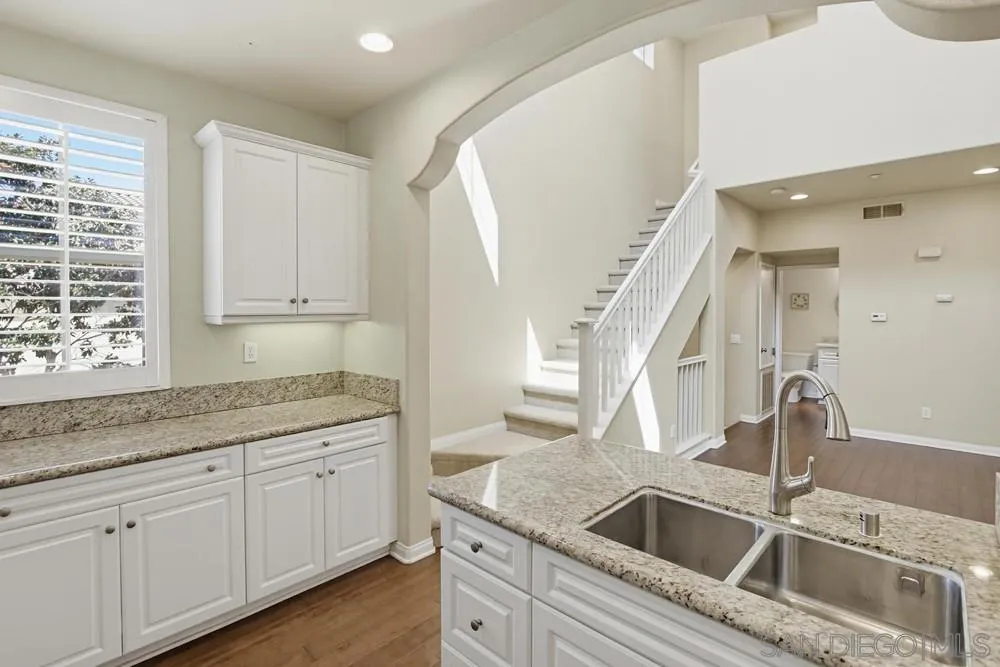 3643 Jetty Point Carlsbad, CA 92010 - Photo 17 of 37 a kitchen with granite countertop a sink and natural light