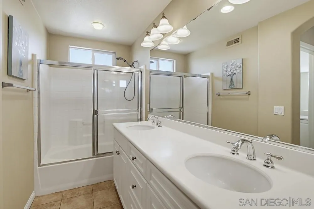 3643 Jetty Point Carlsbad, CA 92010 - Photo 32 of 37 a bathroom with a double vanity sink mirror and shower