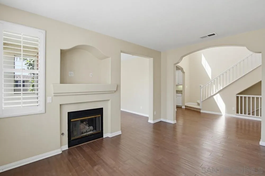 3643 Jetty Point Carlsbad, CA 92010 - Photo 9 of 37 a view of a livingroom with wooden floor and a fireplace