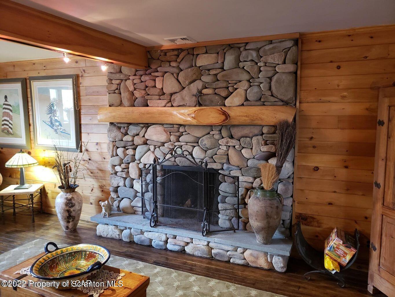 105 Collins Avenue Shavertown, PA 18708 - Photo 40 of 53 a room with fireplace and wooden floor