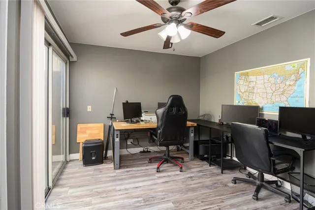 a view of a workspace with furniture and a window