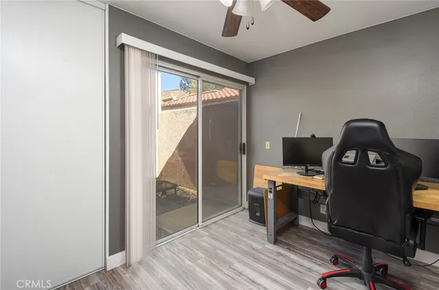a view of a workspace with furniture and a window
