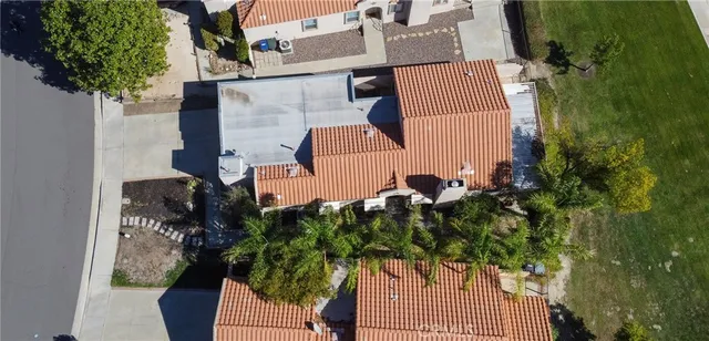 an aerial view of a house with a yard and garden