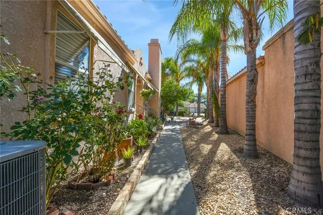 a view of a pathway of a house with a yard