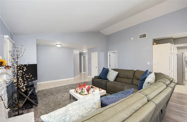 a living room with furniture and flowers