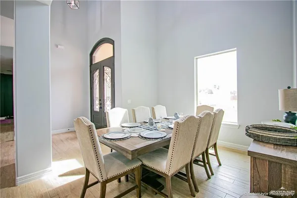 a dining room with furniture and wooden floor