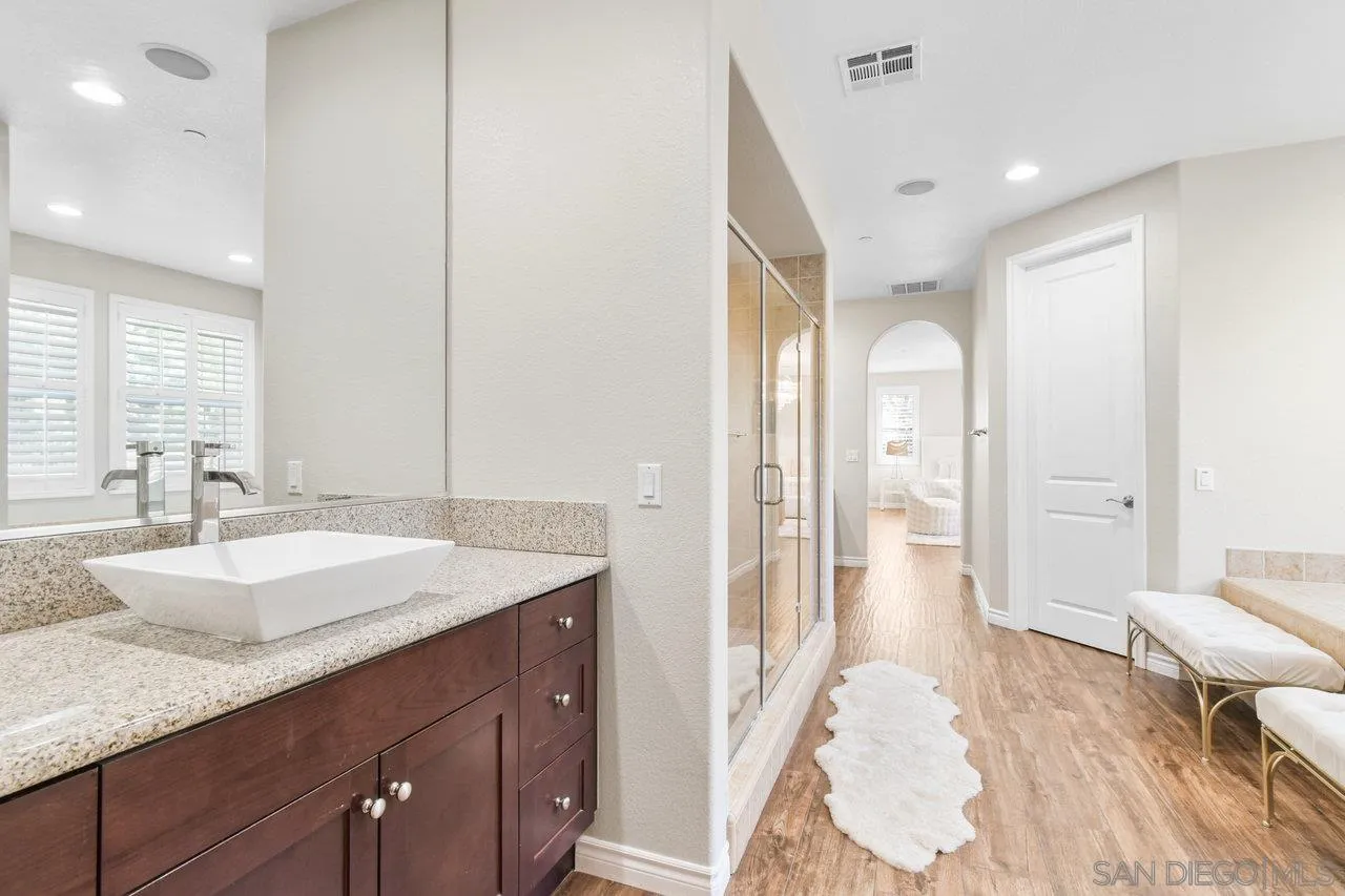 2957 Ranch Gate Road Chula Vista, CA 91914 - Photo 39 of 75 a spacious bathroom with a granite countertop sink and a mirror