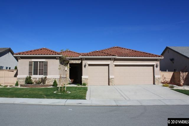 10611 Apple Mill Drive Reno, NV 89521 - Photo 1 of 9 a front view of a house with a yard and garage