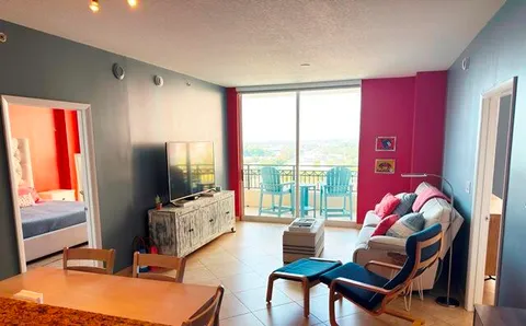 a living room with furniture fireplace and flat screen tv