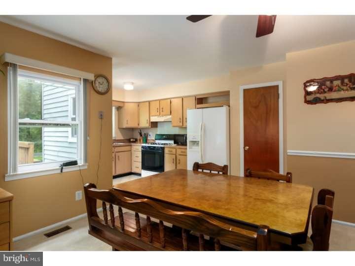 10 Hanover Place Sicklerville, NJ 08081 - Photo 5 of 20 a kitchen with stainless steel appliances kitchen island granite countertop a sink refrigerator and cabinets