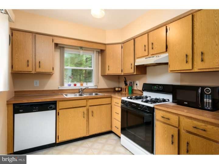 10 Hanover Place Sicklerville, NJ 08081 - Photo 8 of 20 a kitchen with stainless steel appliances granite countertop a stove a sink and white cabinets