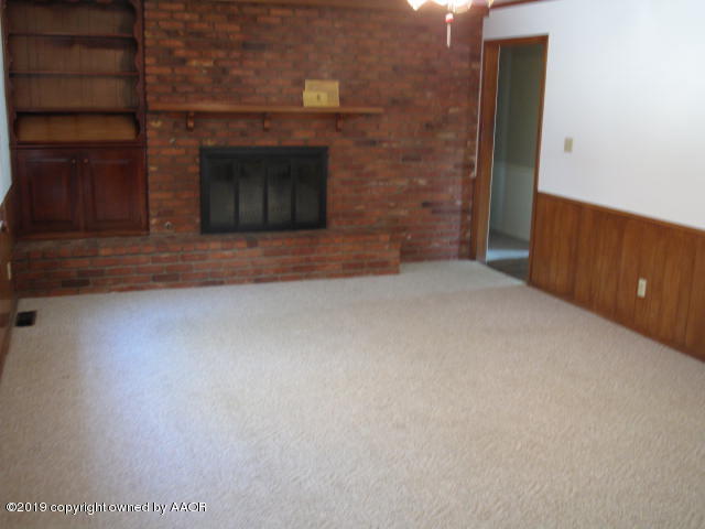 6206 Dreyfuss Road Amarillo, TX 79106 - Photo 3 of 15 a view of an empty room with a fireplace