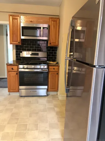 a kitchen with stainless steel appliances a stove and a refrigerator