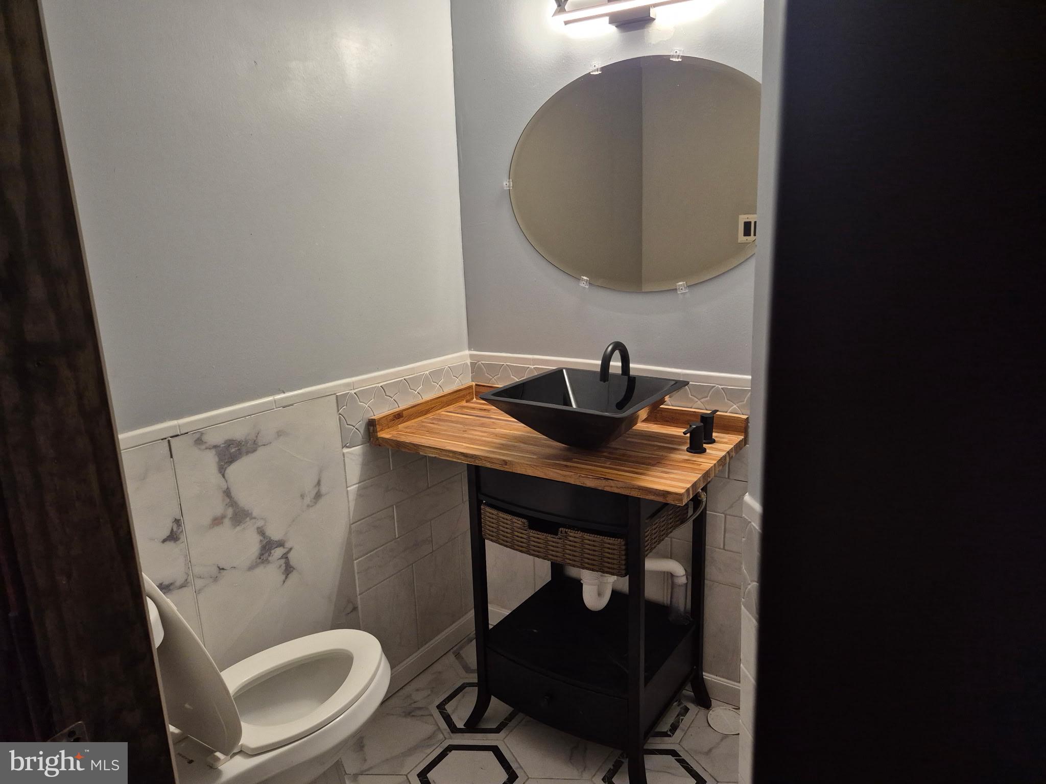710 Smith Lane Mount Holly, NJ 08060 - Photo 11 of 26 a bathroom with a sink a toilet and a mirror