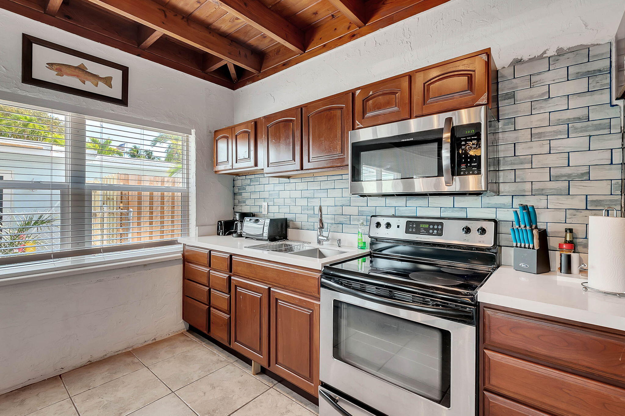108 Long Ben Drive Key Largo, FL 33037 - Photo 22 of 43 a kitchen with stainless steel appliances a stove sink microwave and cabinets