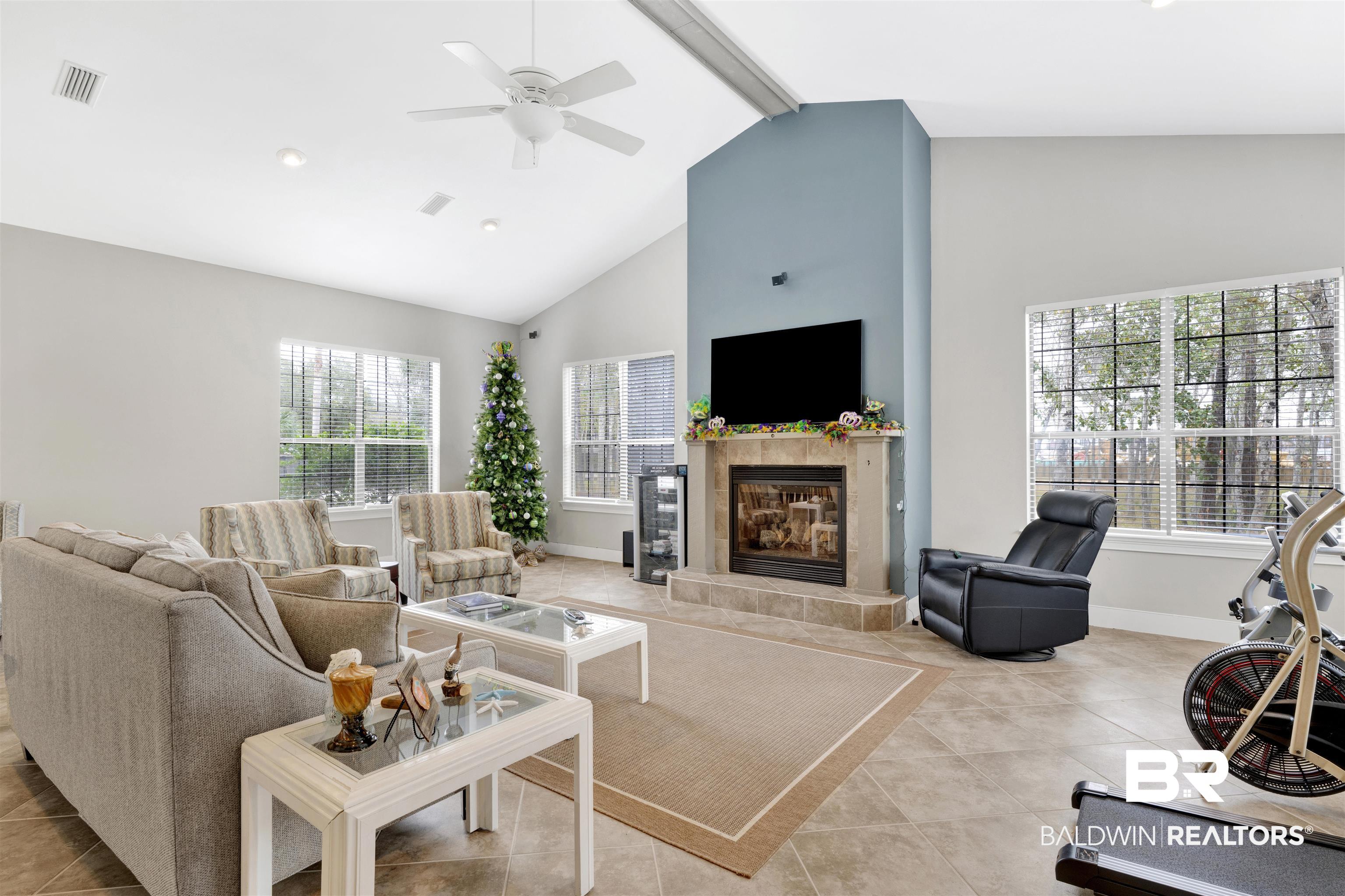 4650 Griffith Marina Road, Unit LOT 24 Orange Beach, AL 36561 - Photo 27 of 34 Living room featuring ceiling fan, a fireplace, and light tile patterned floors