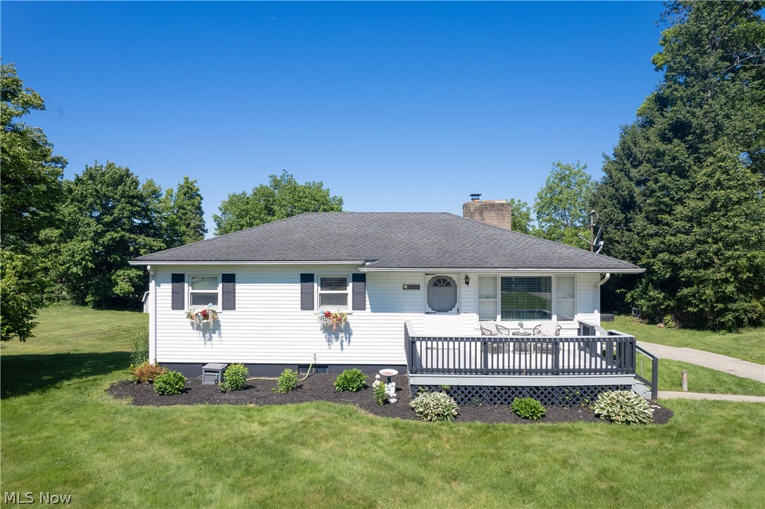 White siding exterior featuring a dark gray deck with matching railings