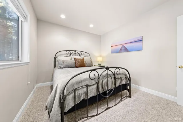 a bedroom with a bed and a window