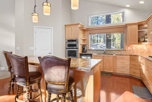 a view of a dining room with furniture a chandelier and wooden floor