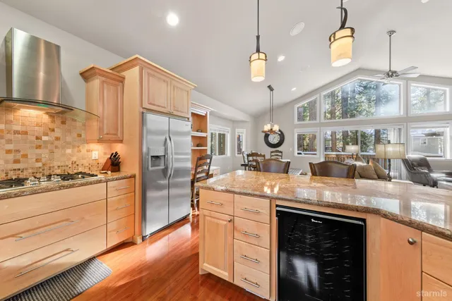 a kitchen with stainless steel appliances granite countertop a stove and a refrigerator