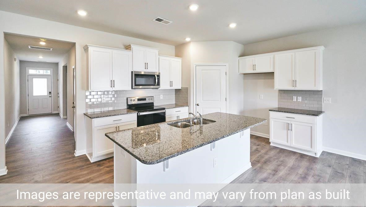 7663 Sand Pit Road Stantonsburg, NC 27883 - Photo 12 of 22 a kitchen with stainless steel appliances granite countertop a sink stove and refrigerator