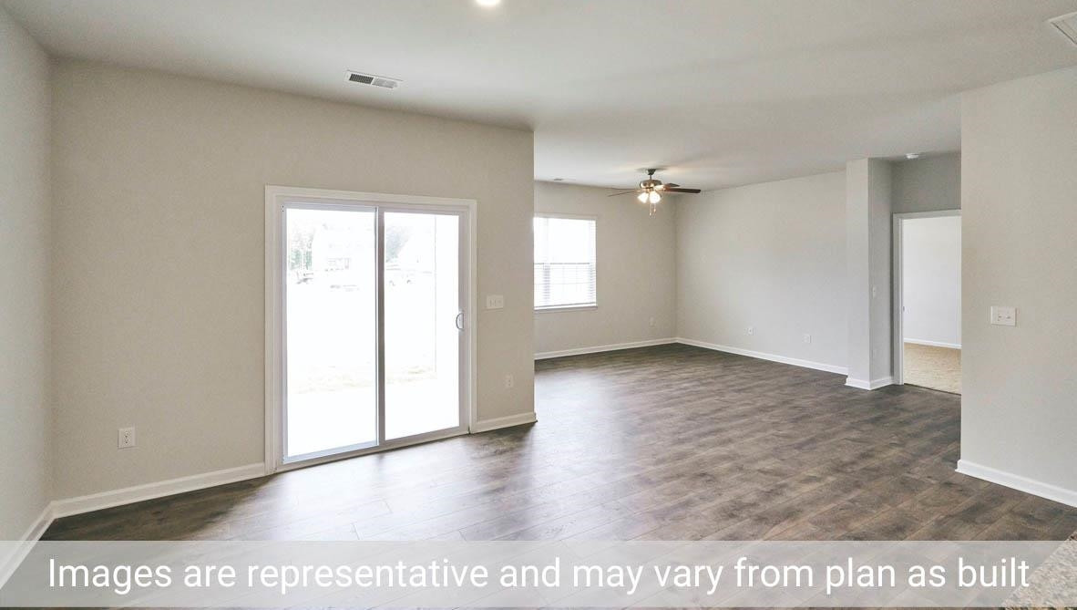 7663 Sand Pit Road Stantonsburg, NC 27883 - Photo 16 of 22 an empty room with wooden floor and windows