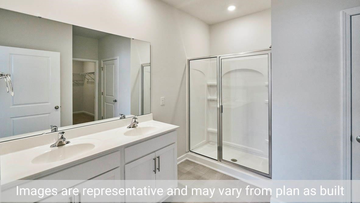 7663 Sand Pit Road Stantonsburg, NC 27883 - Photo 19 of 22 a bathroom with a sink mirror and shower